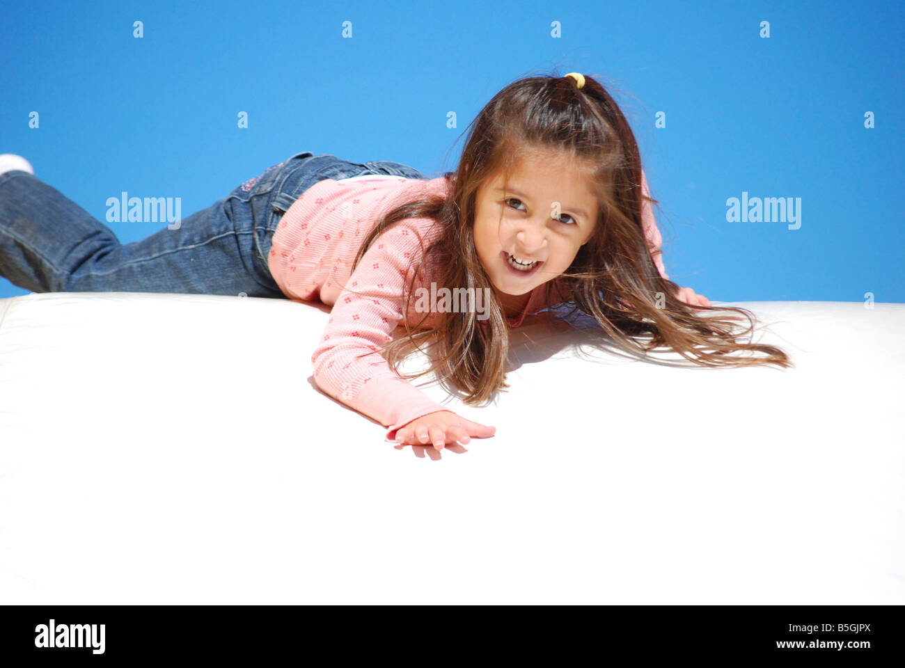Young Mexican girl at top of a slide Stock Photo