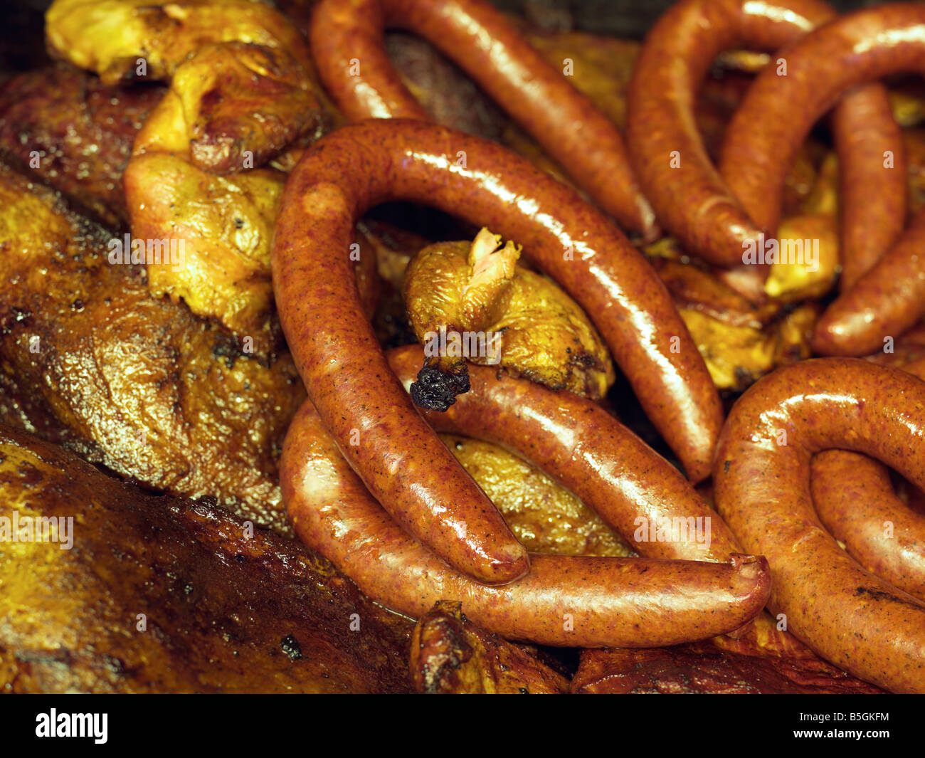 USA,Texas,Houston,Texas BBQ sausage and chicken grilling in an open pit BBQ grill Stock Photo