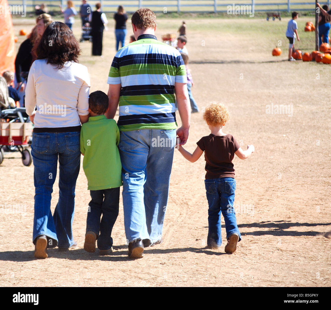 American family walking at a pumpking festival Stock Photo