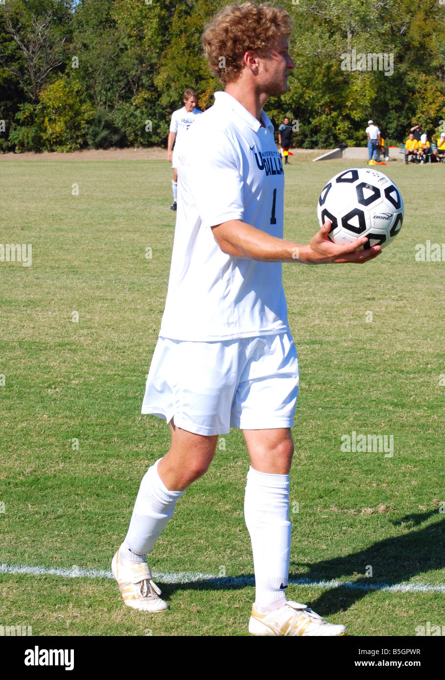 Soccer player holding a ball Stock Photo