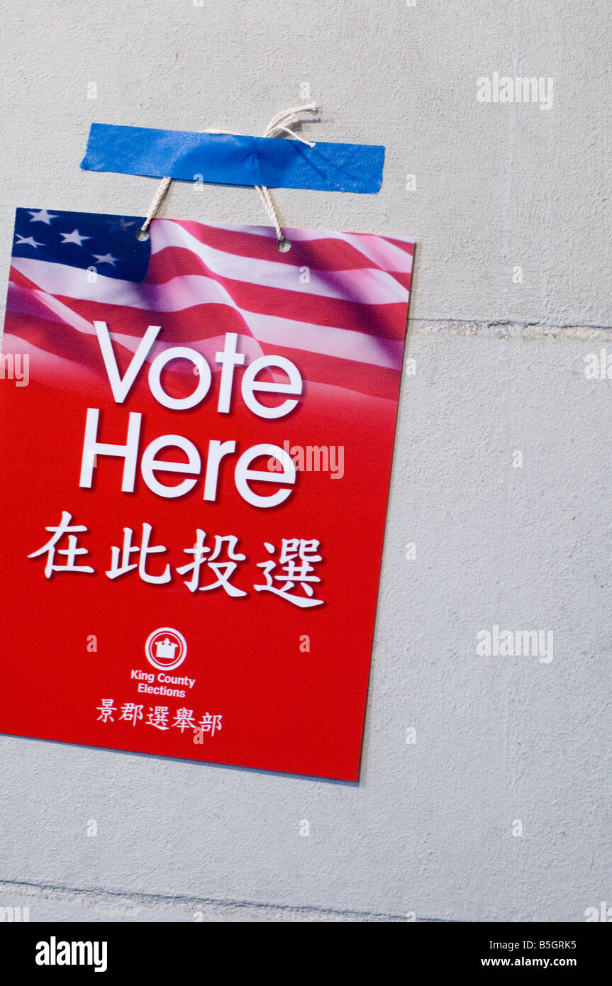 Sign: Vote Here by the polling place on the day of the General Election. USA, WA, Seattle. Stock Photo