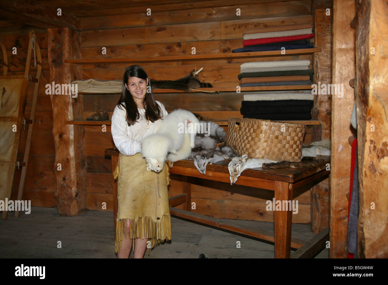 Young woman with Fur Trappers gods for sale at ancient Huron-Jesuit Aboriginal Indian Village near Midland,Ontario,Canada Stock Photo