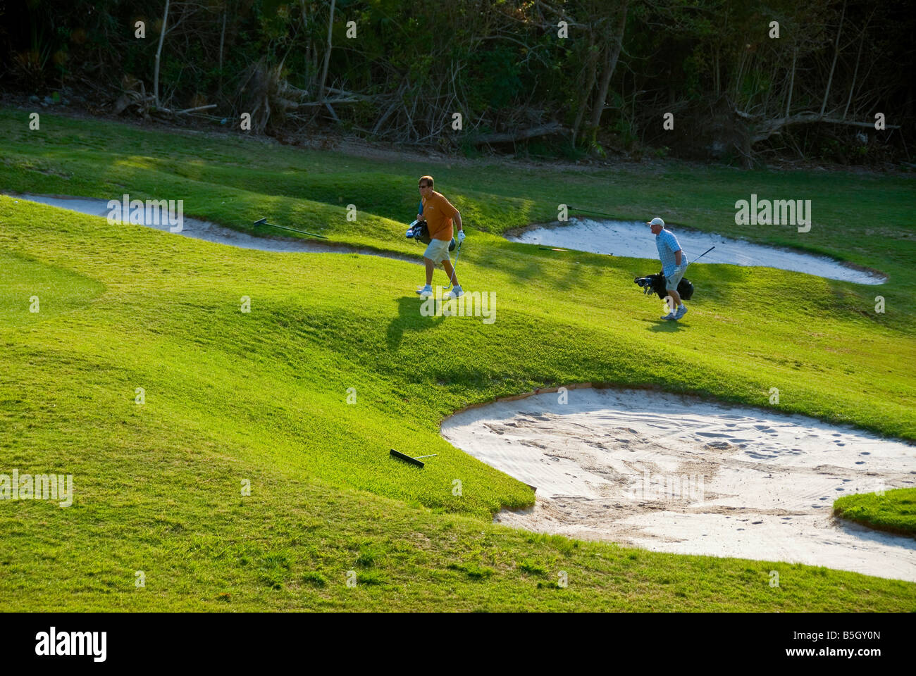 Bermuda golf course st george parish sand trap two men playing golf Stock Photo