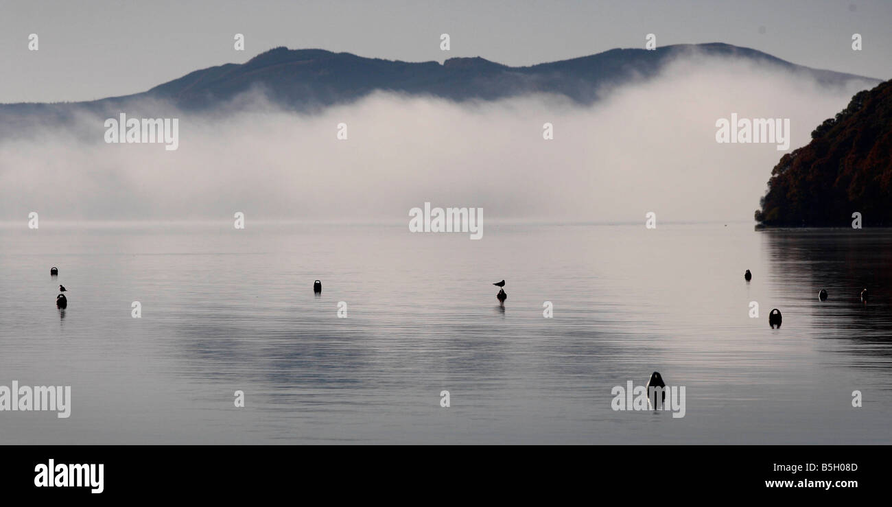 Fog sits over Loch Lomond near Balmaha as Autumn arrives Stock Photo