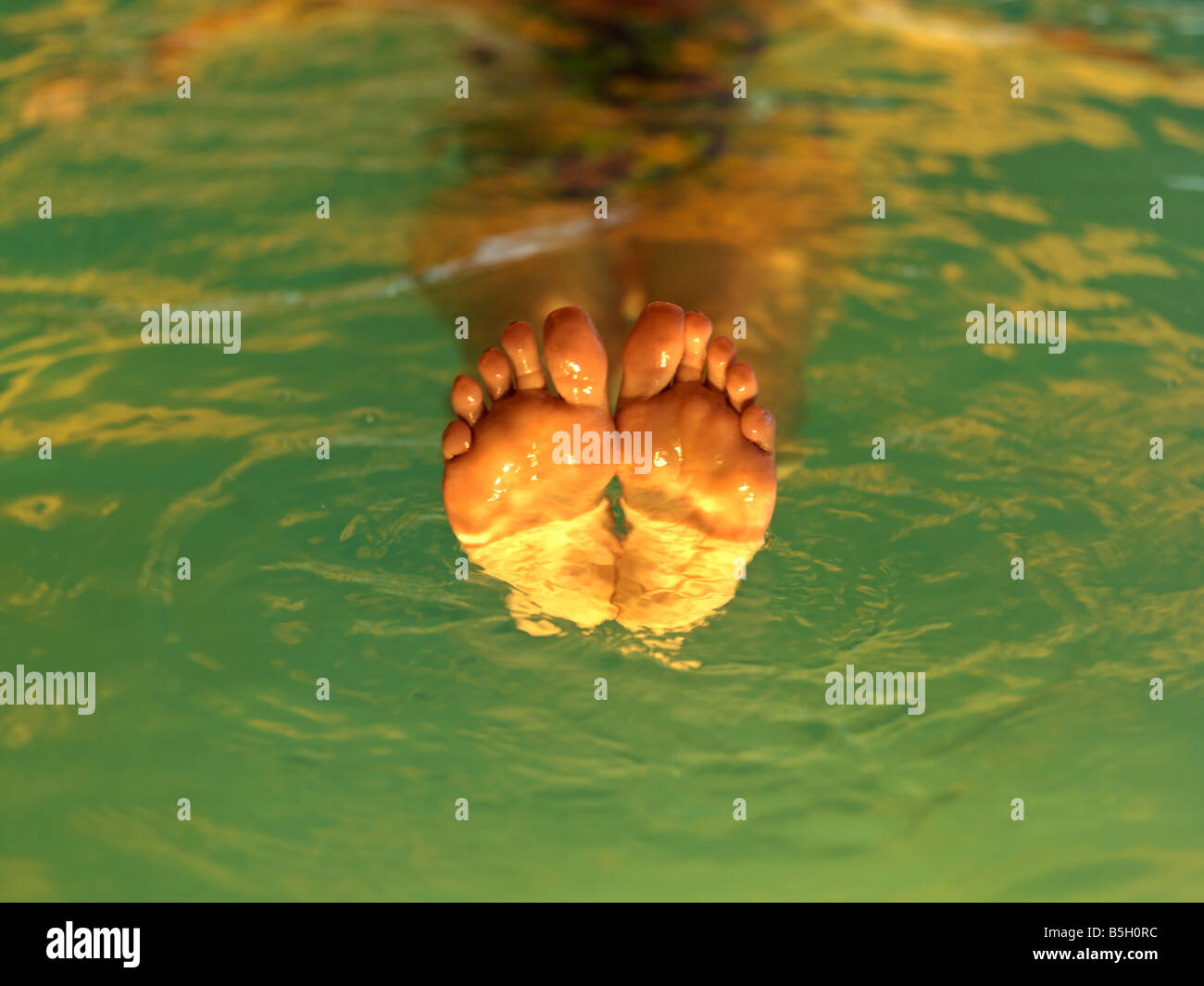 womans legs floating in a pool of water at a spa Stock Photo Alamy