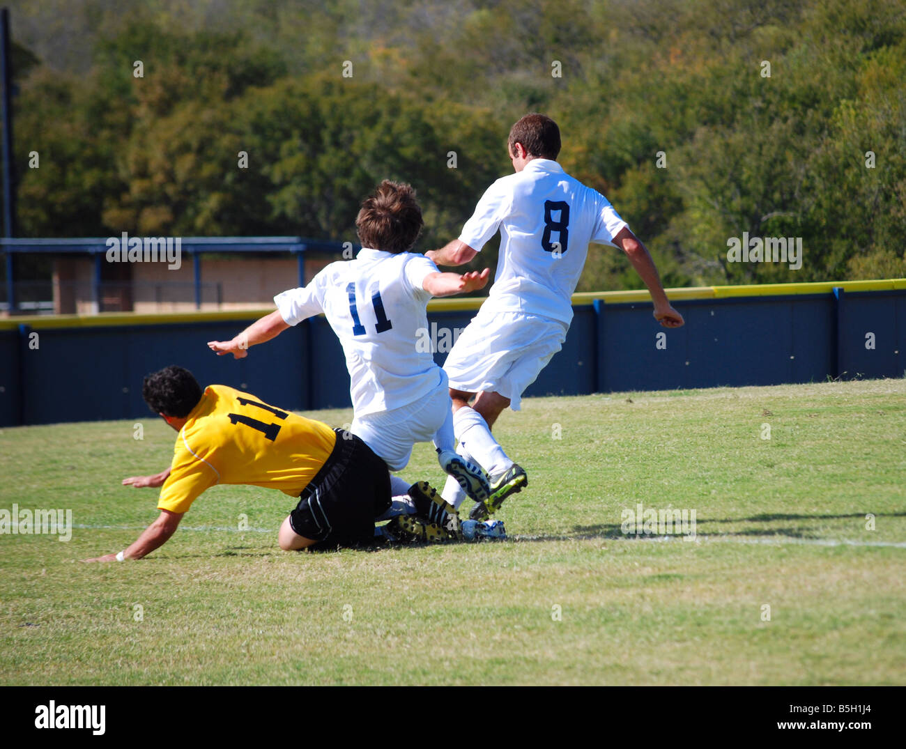 College soccer players fighting for the soccer ball Stock Photo