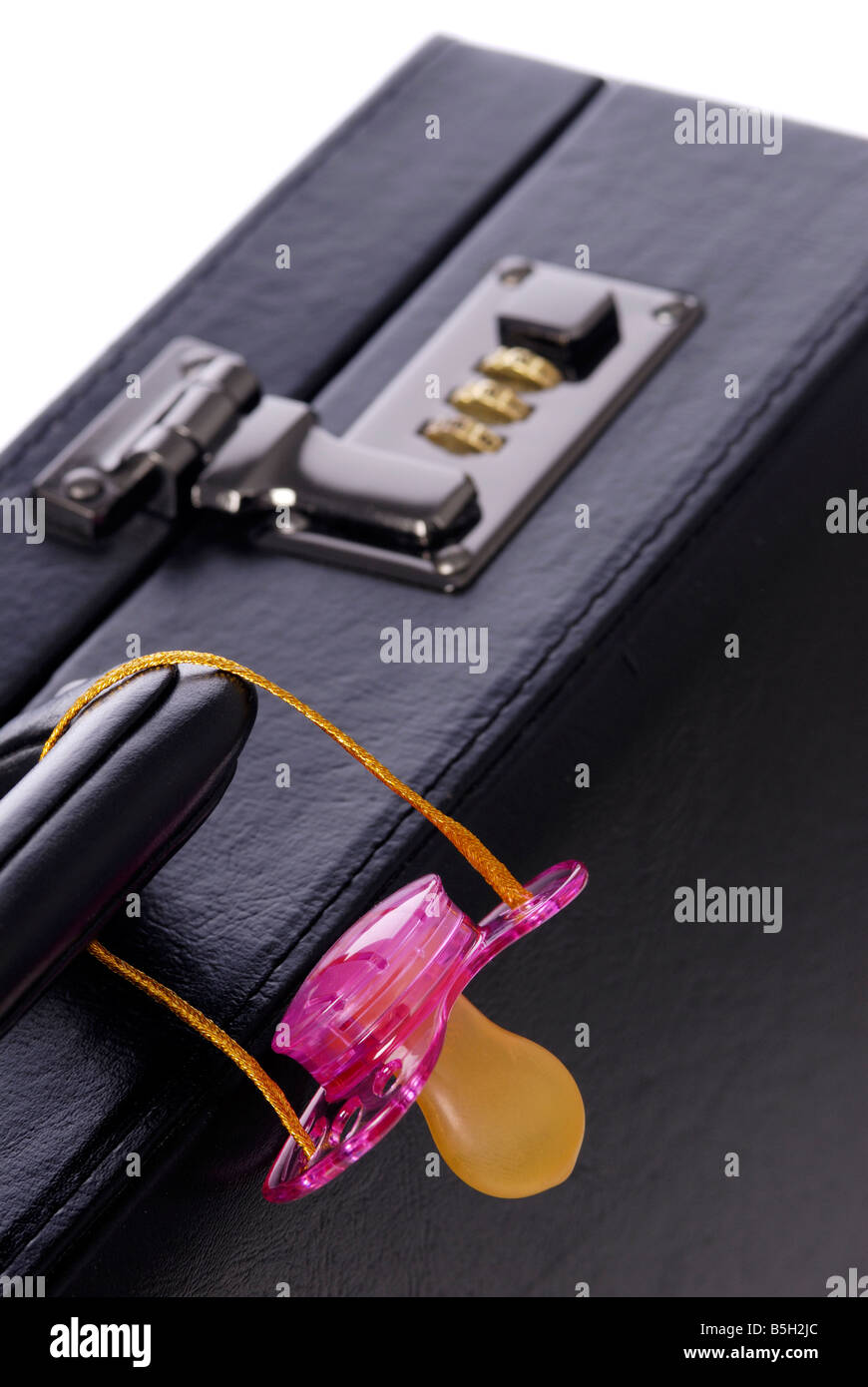 briefcase and a pink soother Stock Photo