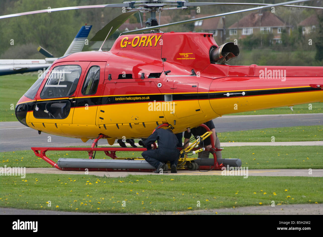 Mechanics repairing Working On A Red and Yellow Helicopter G ORKY