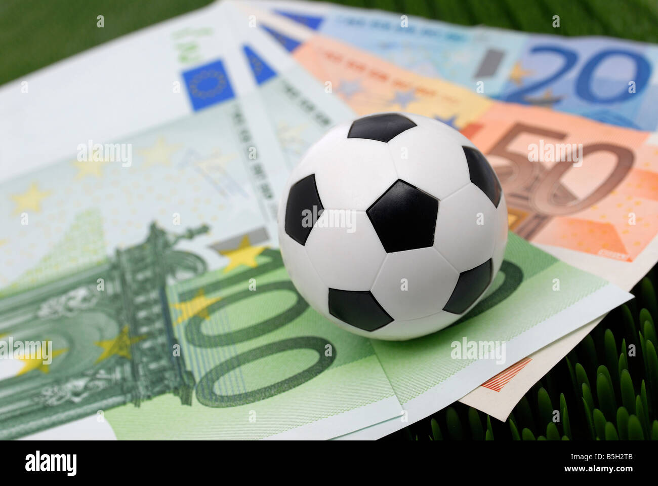 bank notes and a football, symbol for soccer and commerce Stock Photo