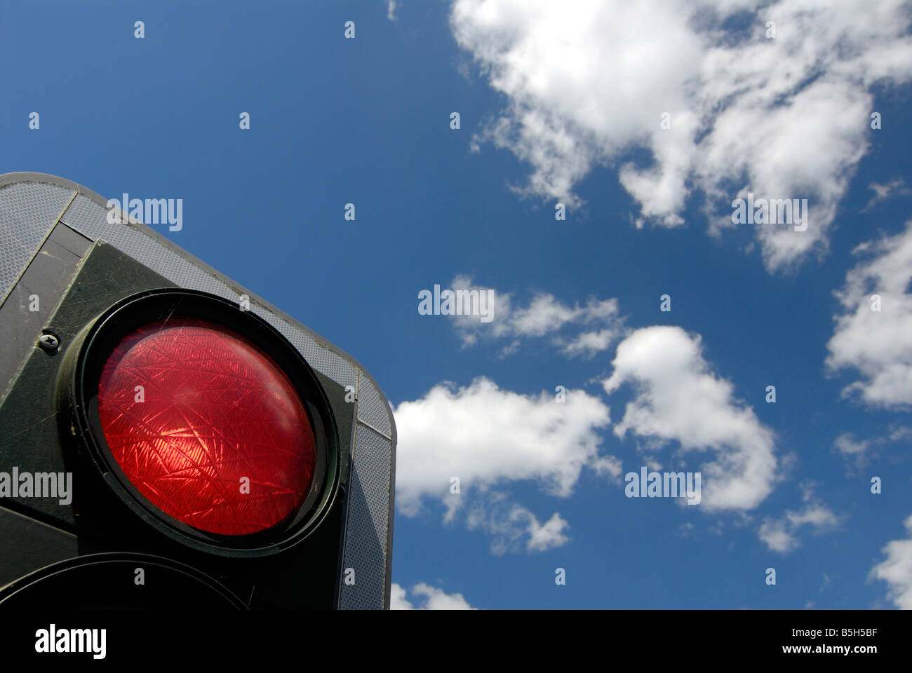 red traffic light and a blue sky Stock Photo