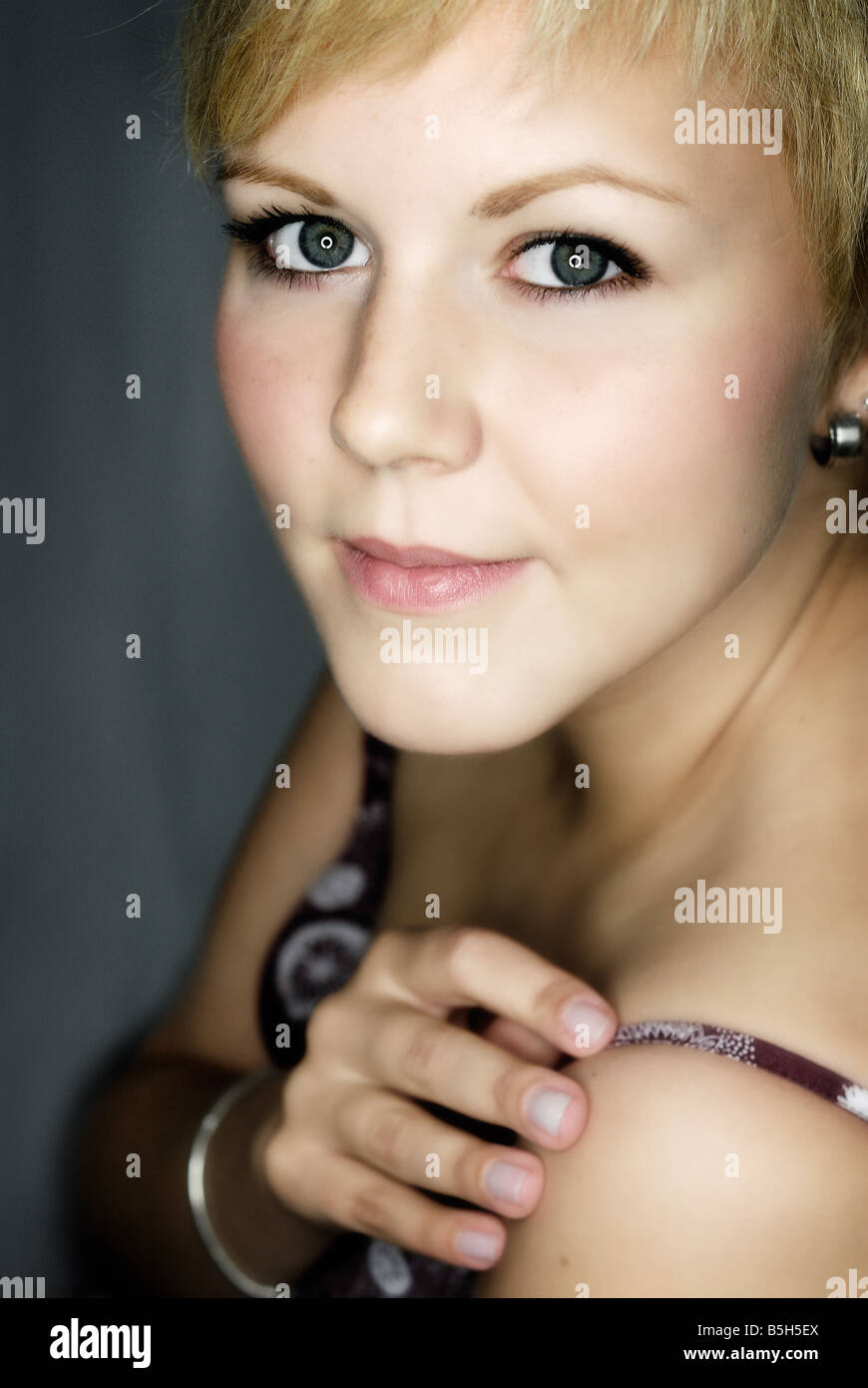 portrait of a young woman with blond short hair wearing a tank top Stock Photo