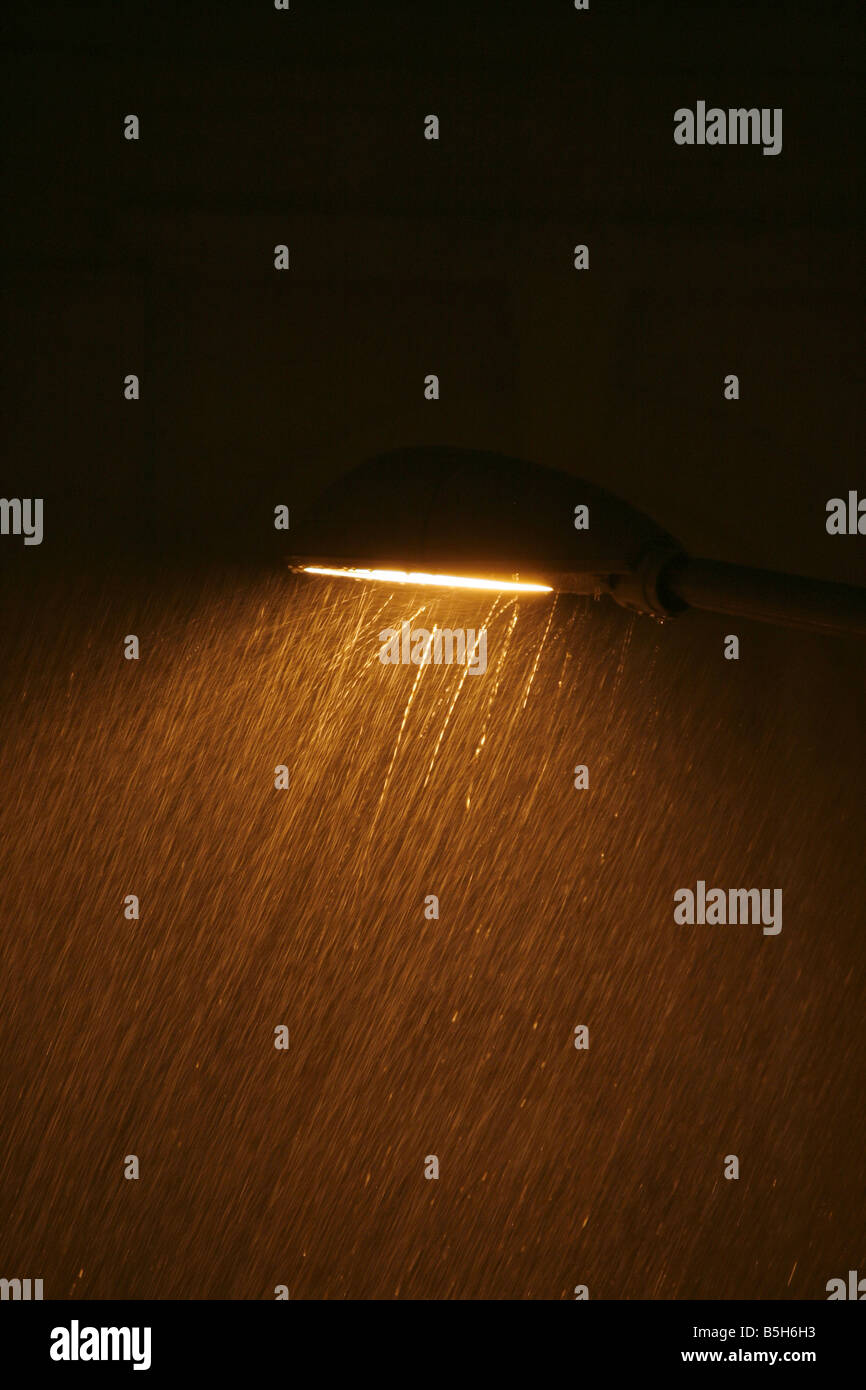 one street lamp in heavy rain at night city town Stock Photo - Alamy