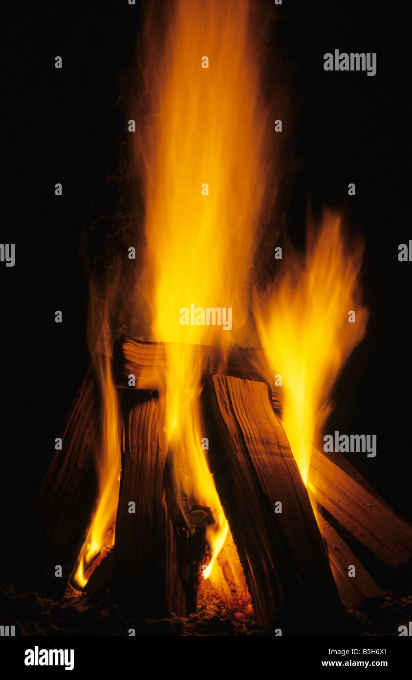 Split logs burning in open hearth fireplace Stock Photo - Alamy