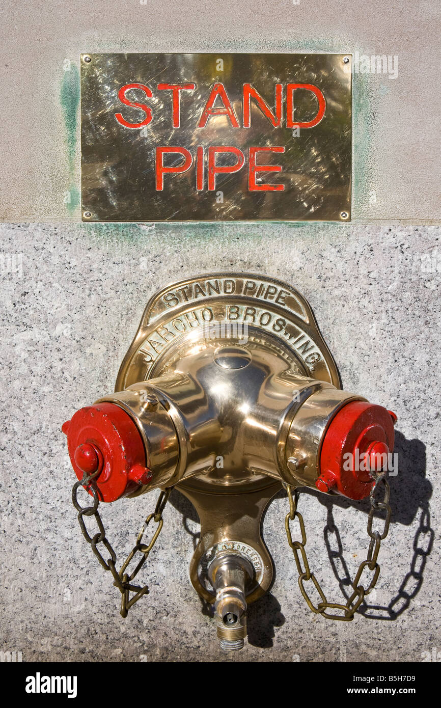 Fire Hydrant in wall of Skyscraper, Manhattan, New York City, USA Stock Photo