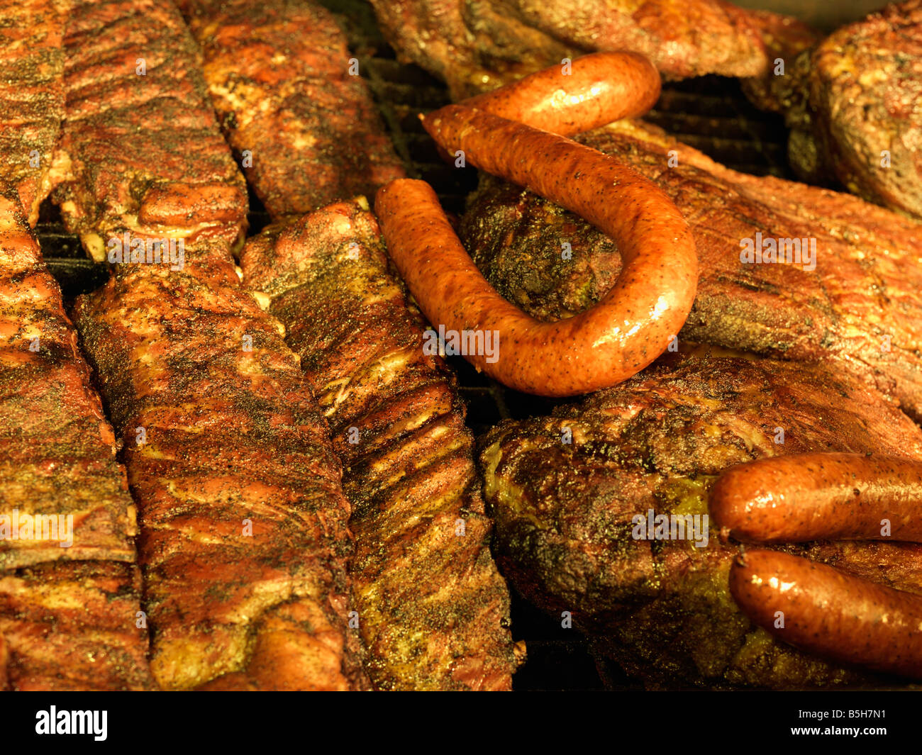 USA,Texas,Houston,sausage ribs and beef brisket grilling in an open pit