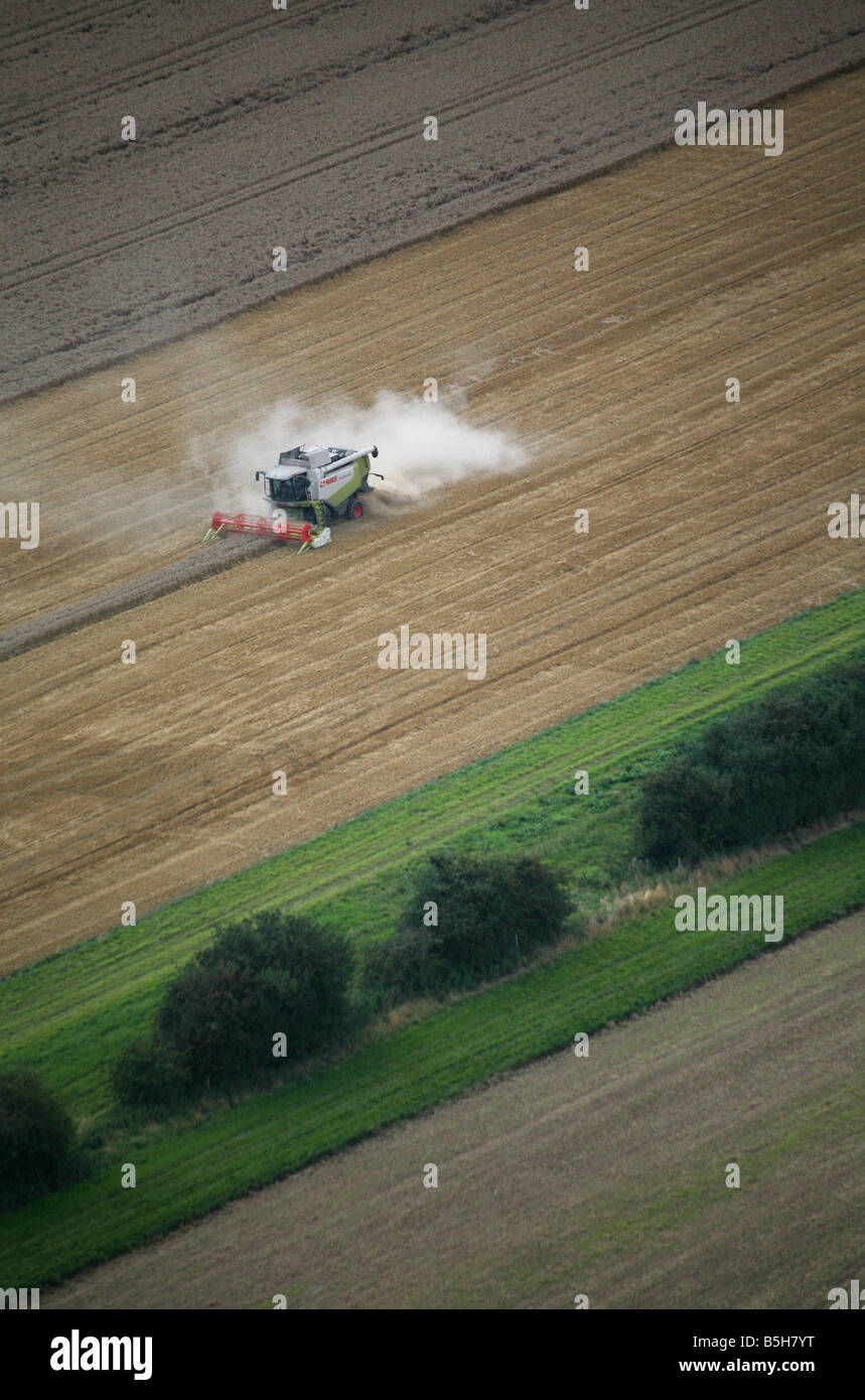 Aerial picture shows a combine harvester and tractor working using satelitte navigation in a fiield near Clare in Suffolk Stock Photo