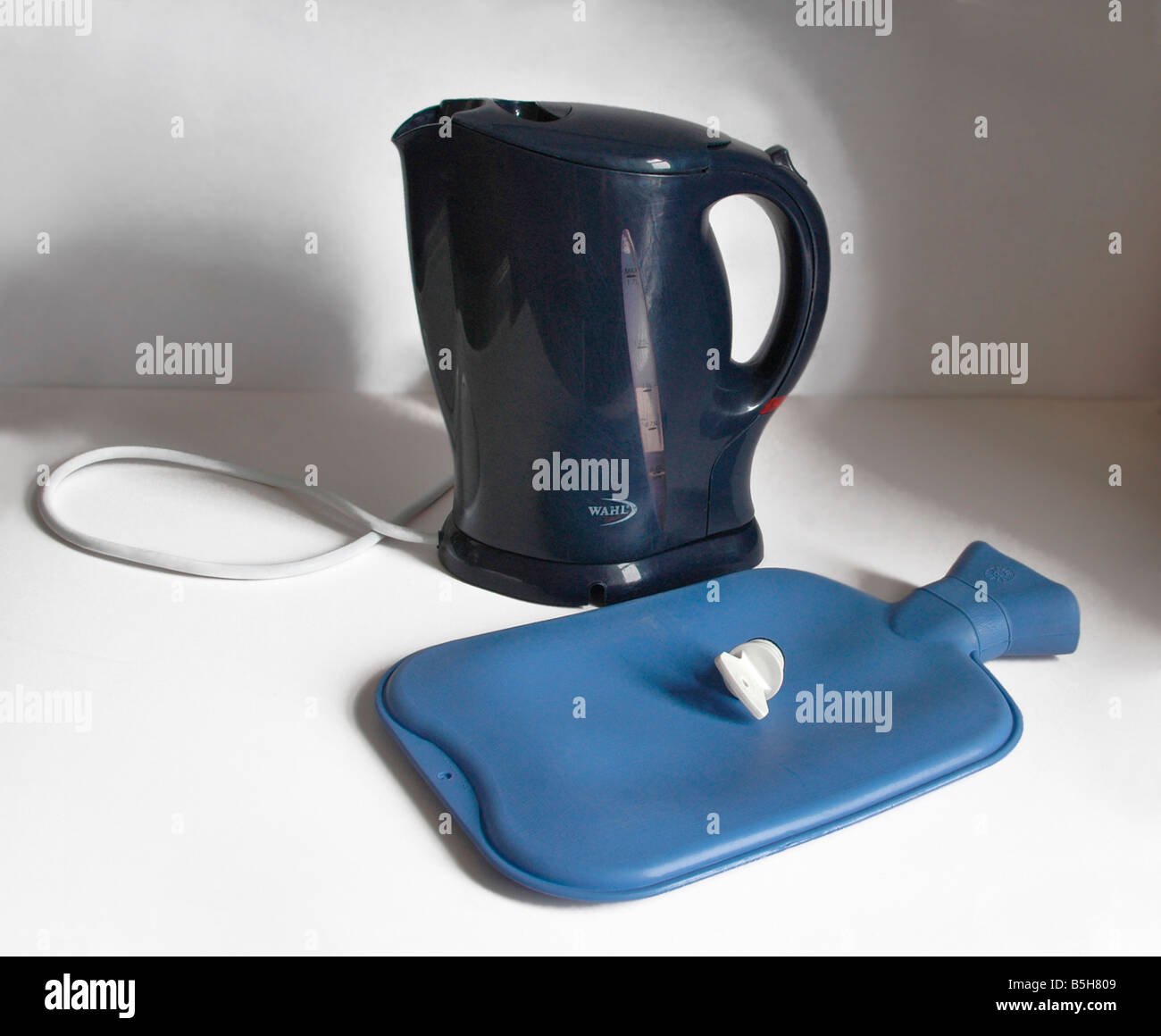 An electric kettle and hot water bottle. Stock Photo