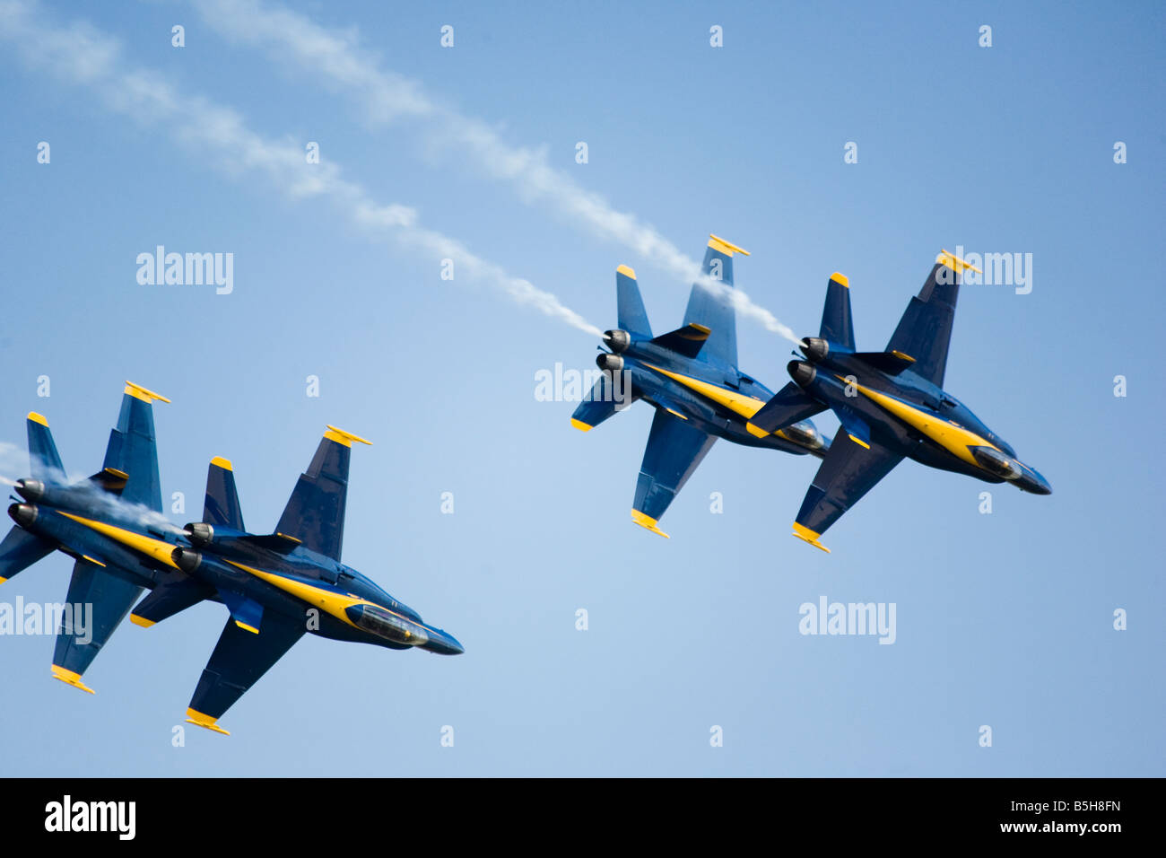 The elite U.S. Navy Blue Angels speed in formation at hundreds of miles per hour at the 2008 Joint Service Open House air show. Stock Photo