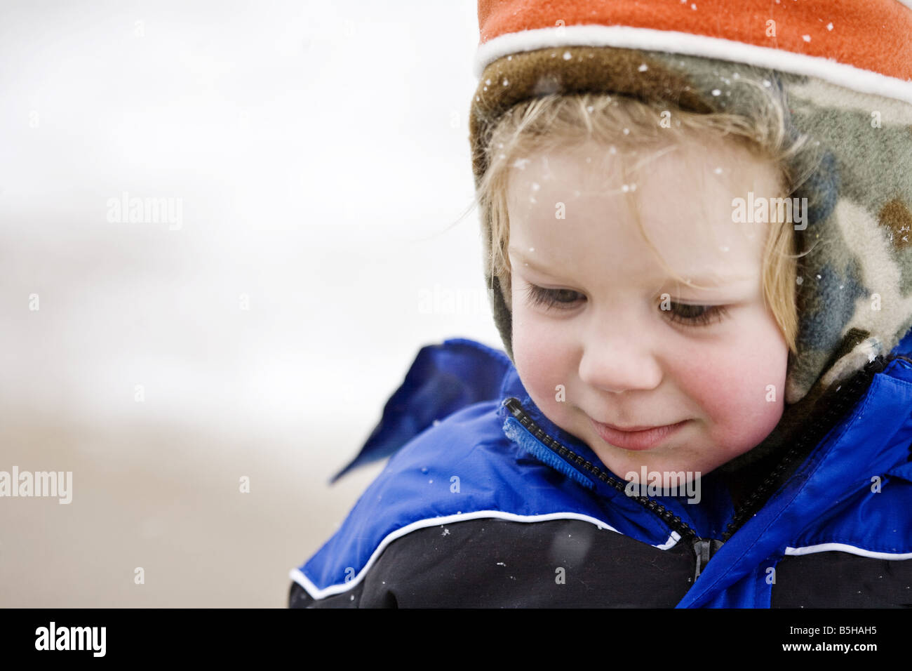 A toddler boy playing in the winter snow Stock Photo - Alamy