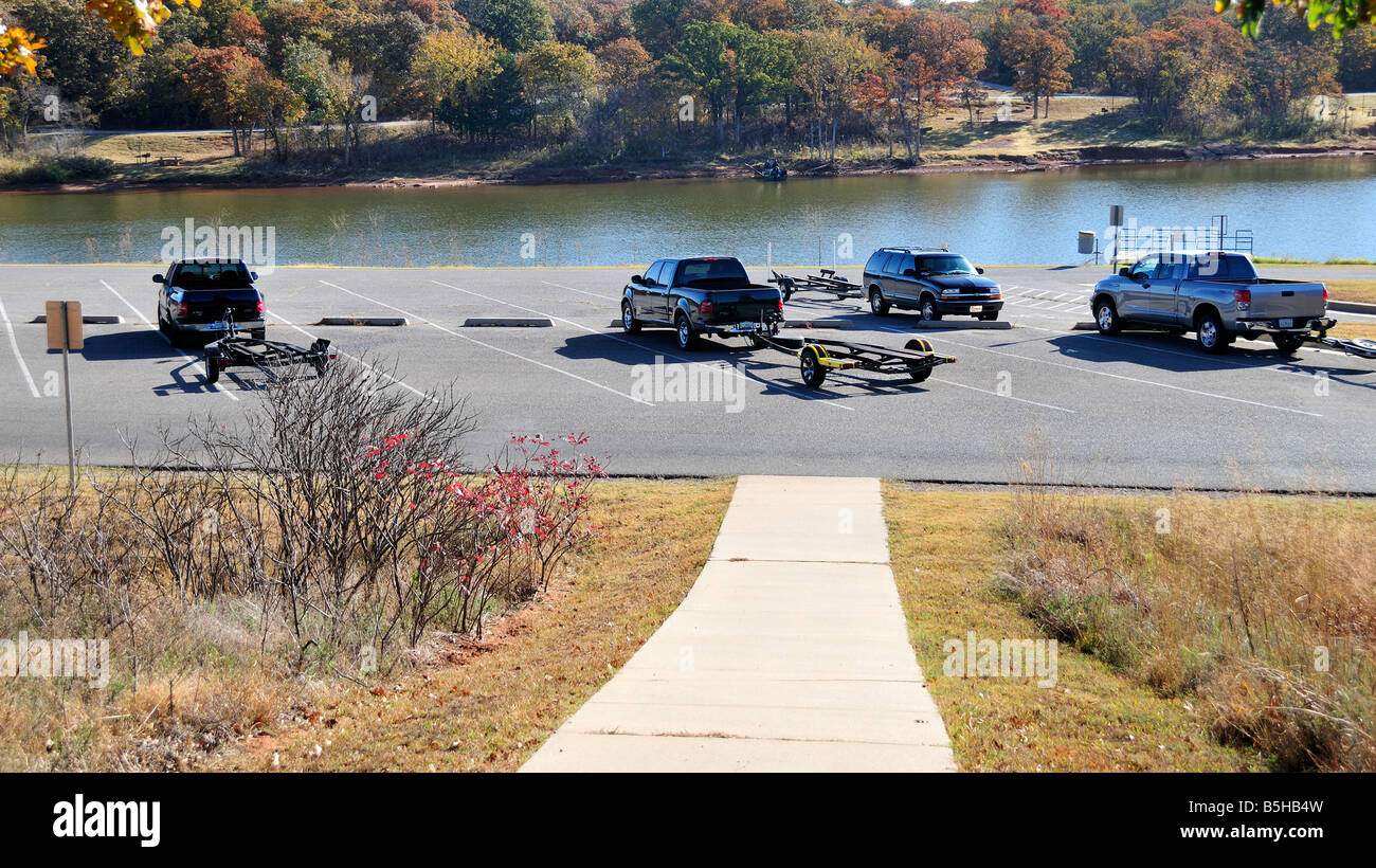 A parking lot for vehicles and boat trailers near an unloading ramp to