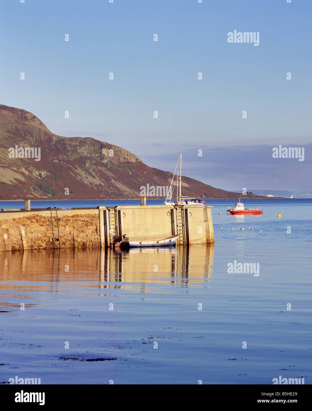 Lamlash Pier and the Holy Island off Isle of Arran, North Ayrshire, Scotland, UK. Stock Photo