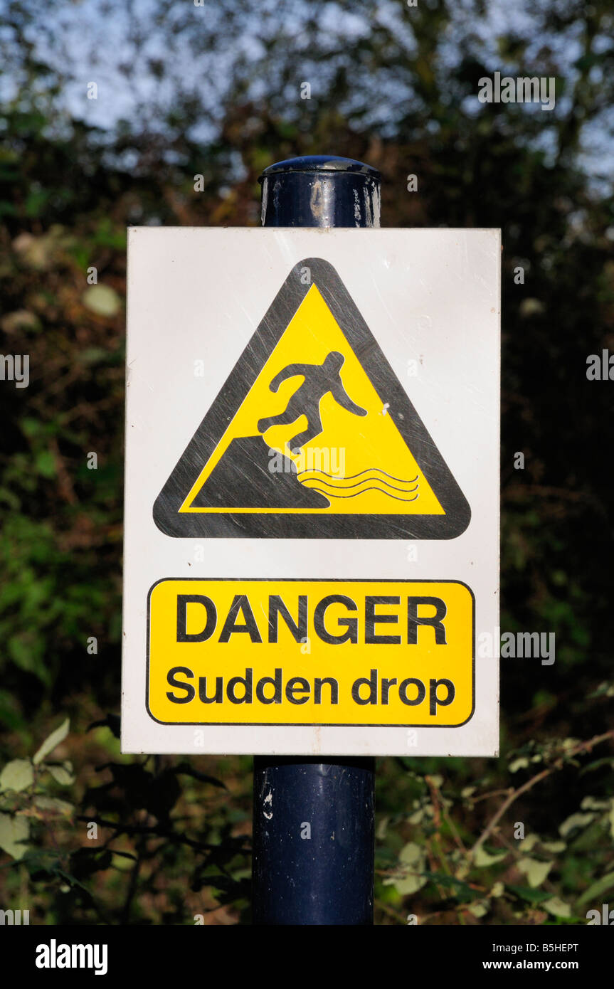 Danger Suidden Drop warning sign by a ditch at  Milton Country Park Cambridgeshire England UK Stock Photo