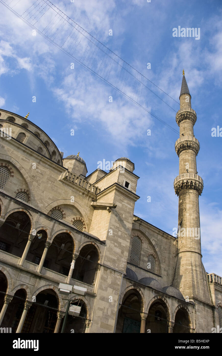 The Blue Mosque set against a blue sky, showing the domed ceiling and minaret tower, in Istanbul, Turkey. Stock Photo