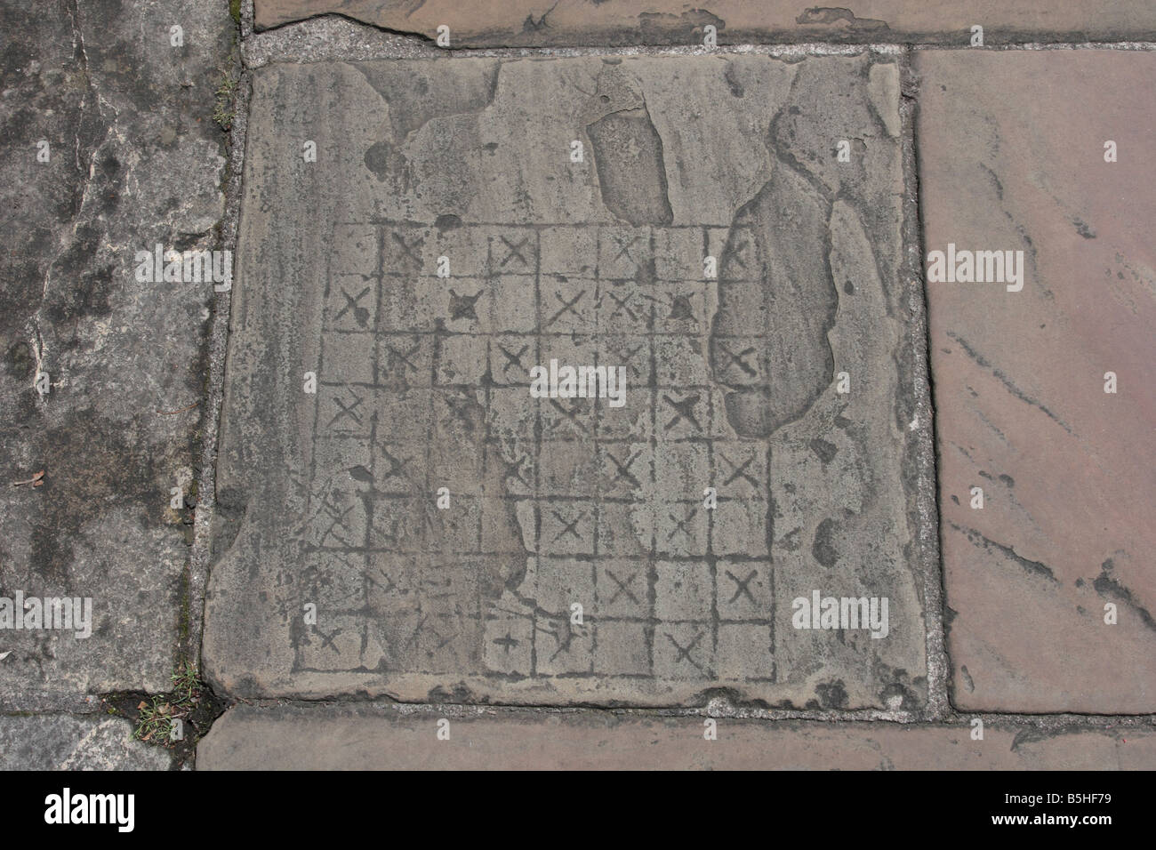 Flagstone with games board etched onto it; on the walkway of the York