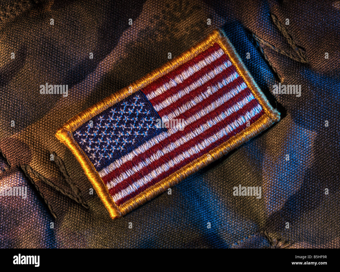 Detachable US flag patch on military camouflage fabric Stock Photo