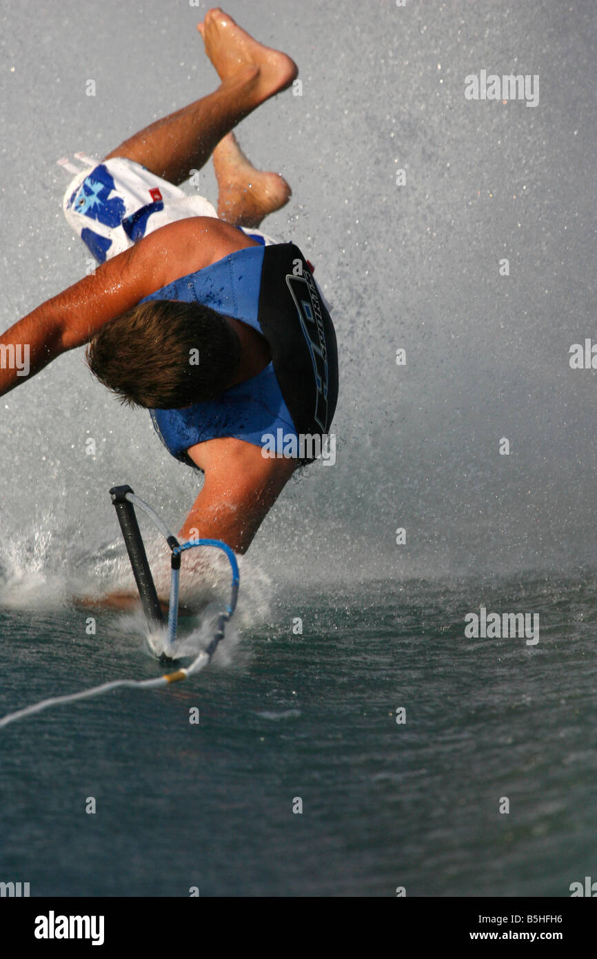 A barefoot waterskier in a mid-air fall. Stock Photo