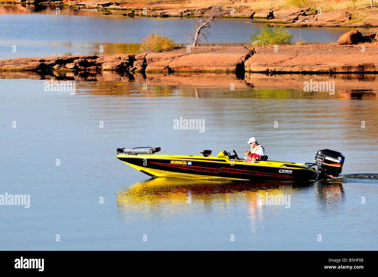 A man and his small son travel across a lake in a fishing boat. Arcadia