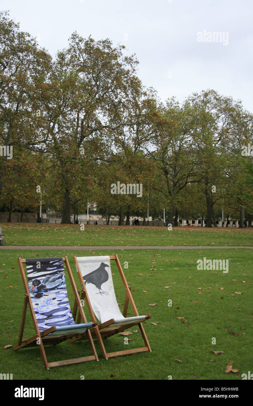 Two empty deckchairs on a grey autumn day in St James Park London Stock Photo