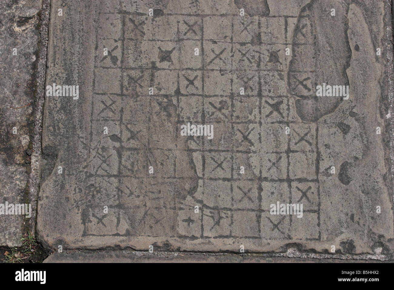 Flagstone with games board etched onto it; on the walkway of the York city walls. York,England