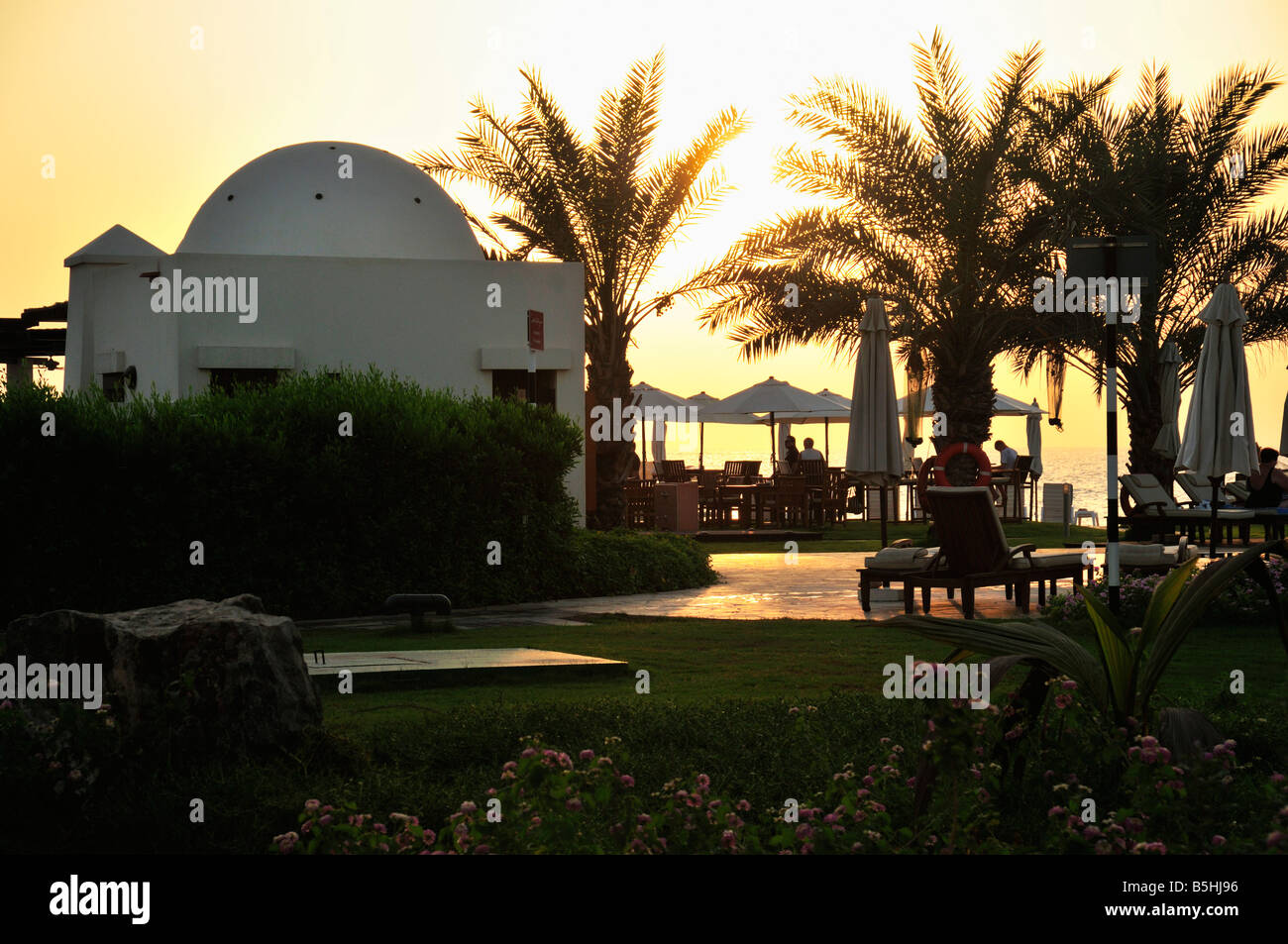 Sunset at Beach Bar Waterfront, Ras Al Khaimah UAE Stock Photo