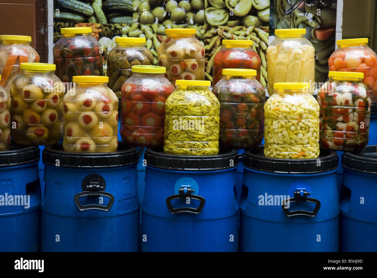 Jars of pickled vegetables for sale on top of blue plastic tubs in the Karakoy bazaar on the Asian side of Istanbul, Turkey. Stock Photo