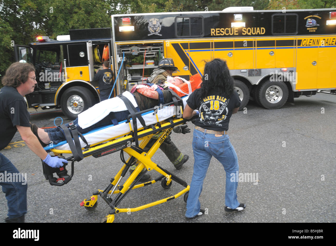Rescuers rush a seriously injured on a stretcherman to a waiting ...