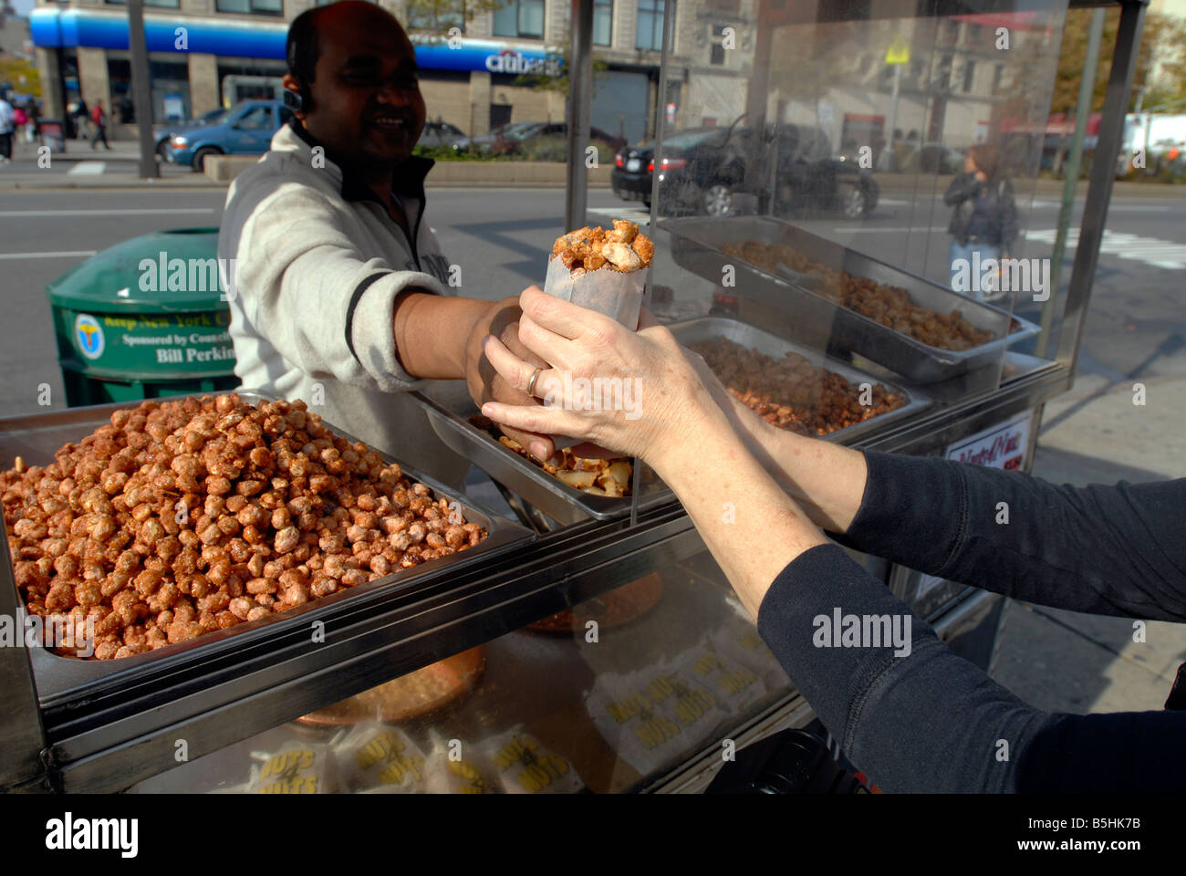 Roasted nut vendor works stand hires stock photography and images Alamy