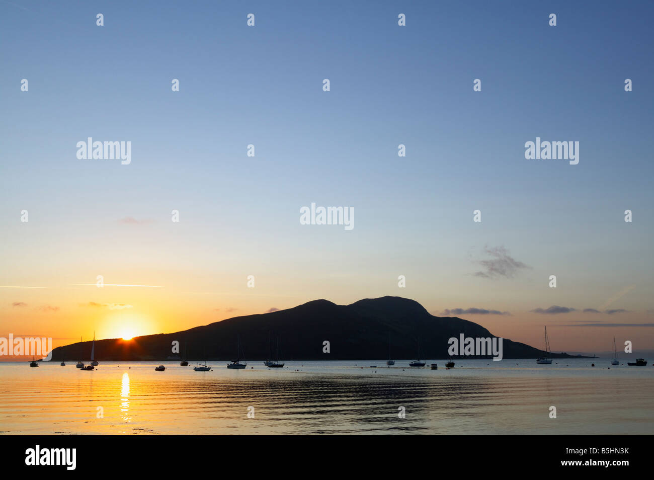 Holy Island off Isle of Arran, North Ayrshire, Scotland, UK. Seen across Lamlash Bay at sunrise. Stock Photo