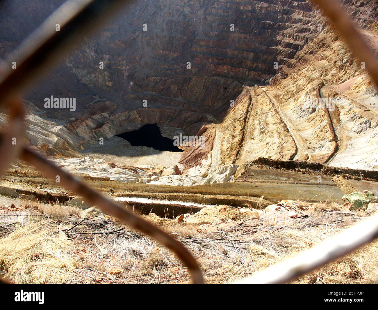 The Lavender Pit mine in Bisbee seen through the metal fence Stock Photo