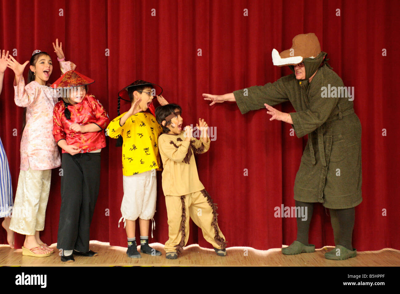 children being frightened by a dragon at a children´s amateur theatre Stock Photo