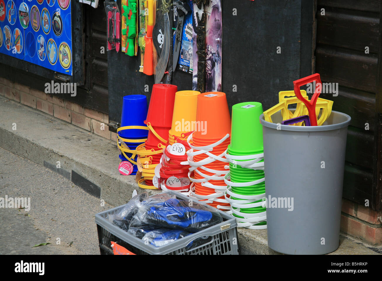 Bucket and spade display outside beach shop at Lulworth Cove Dorset