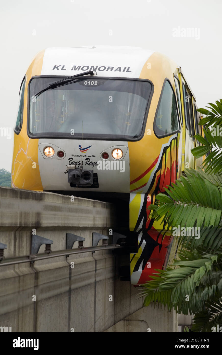 A train approaches a station on the raised KL Monorail public transport network, Malaysia Stock Photo