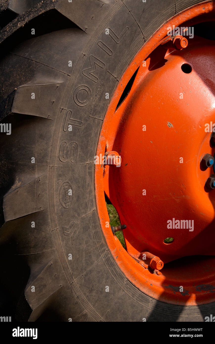 Orange tractor wheel and black tyre on a restored Fordson Major vintage ...