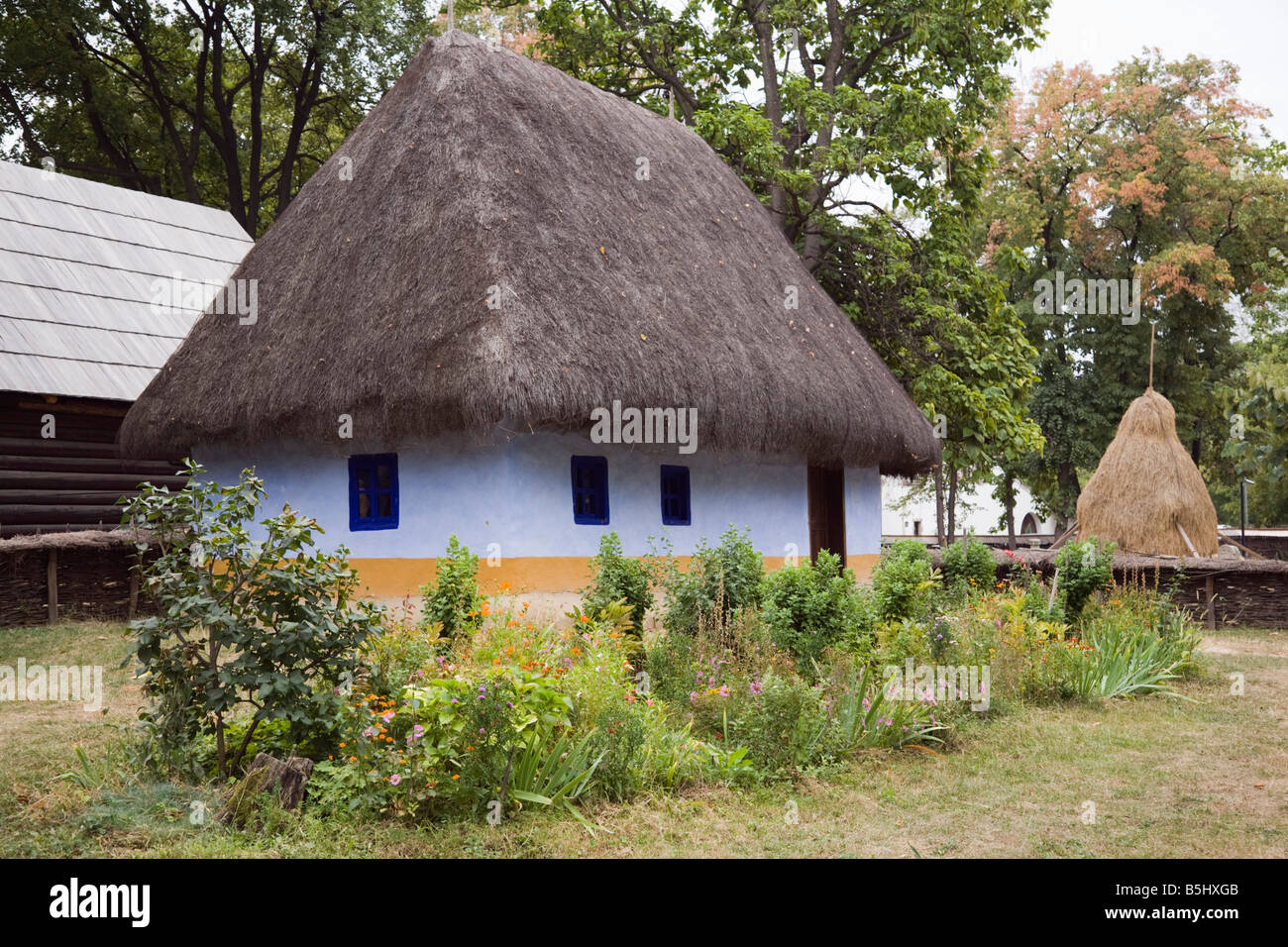 19th century Transylvanian thatched peasant house in outdoor Village Museum Muzeul Satului in Herastrau Park. Bucharest Romania Stock Photo