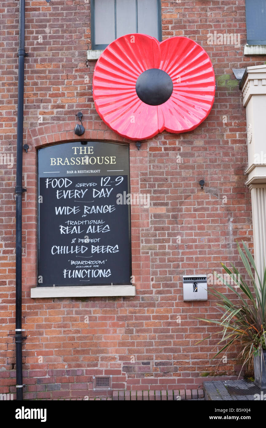 Large poppy on the wall of a Bar, ready for the remembrance day parade, Birmingham Broad Street Stock Photo