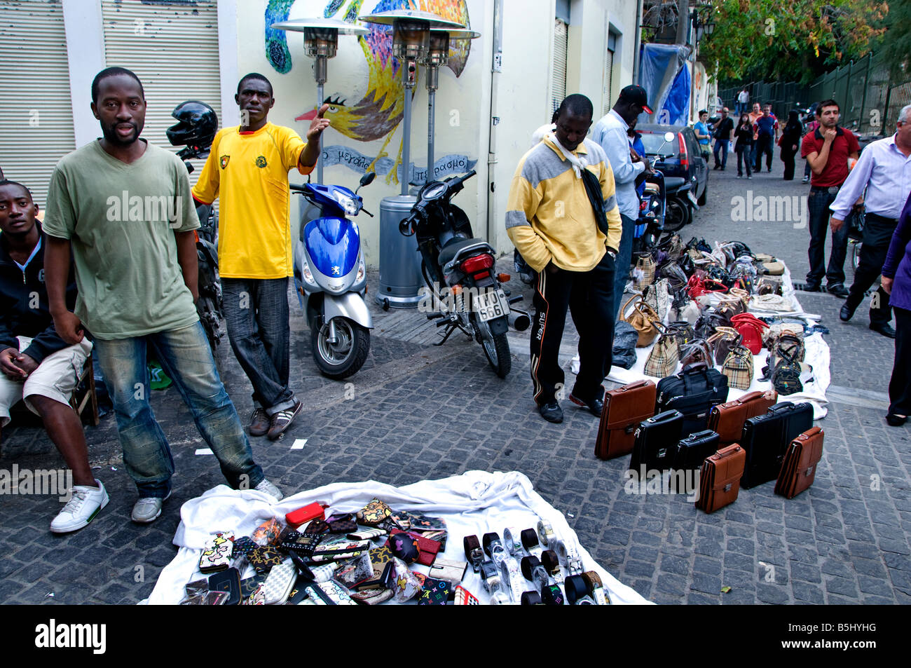 Athens Plaka shopping district underground clandestine immigrant immigration from Africa selling fashion bags Greek Greece Stock Photo