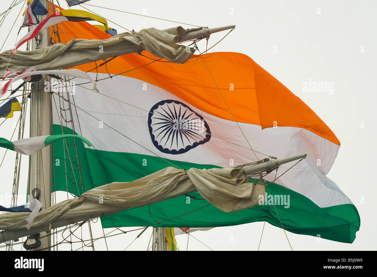 The Indian flag flies from the mast of the Indian Navy's training ship 'Tarangini'. Stock Photo