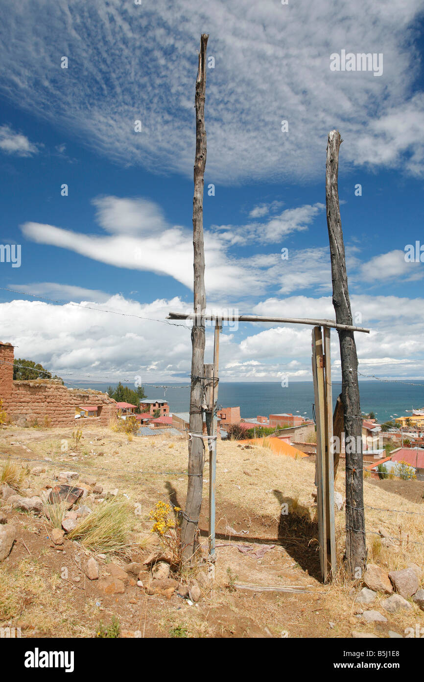 Gateway in fence with view of the Bolivian side of Lake Titicaca Stock Photo