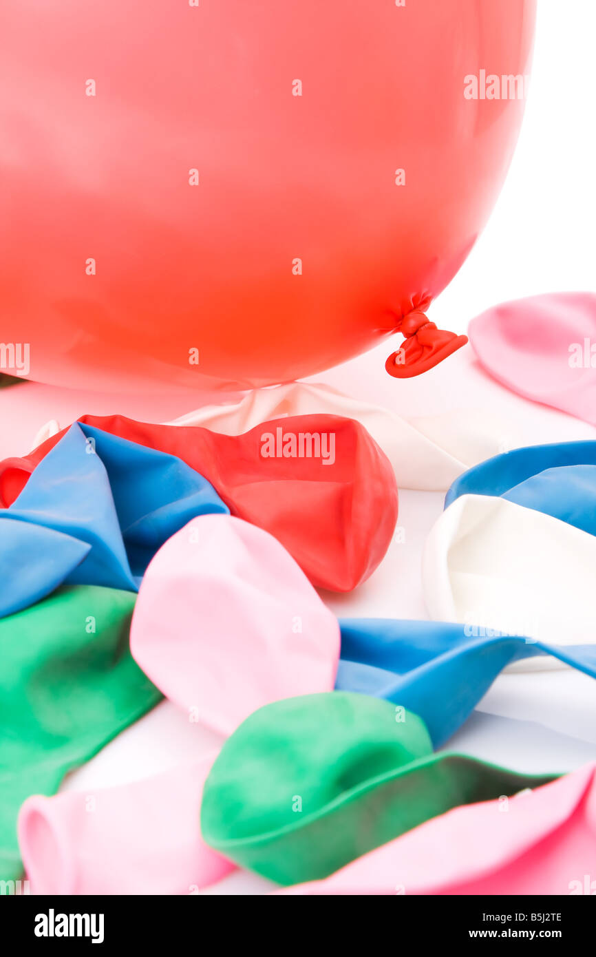 Colorful balloons piled with one inflated and the other empty Stock Photo