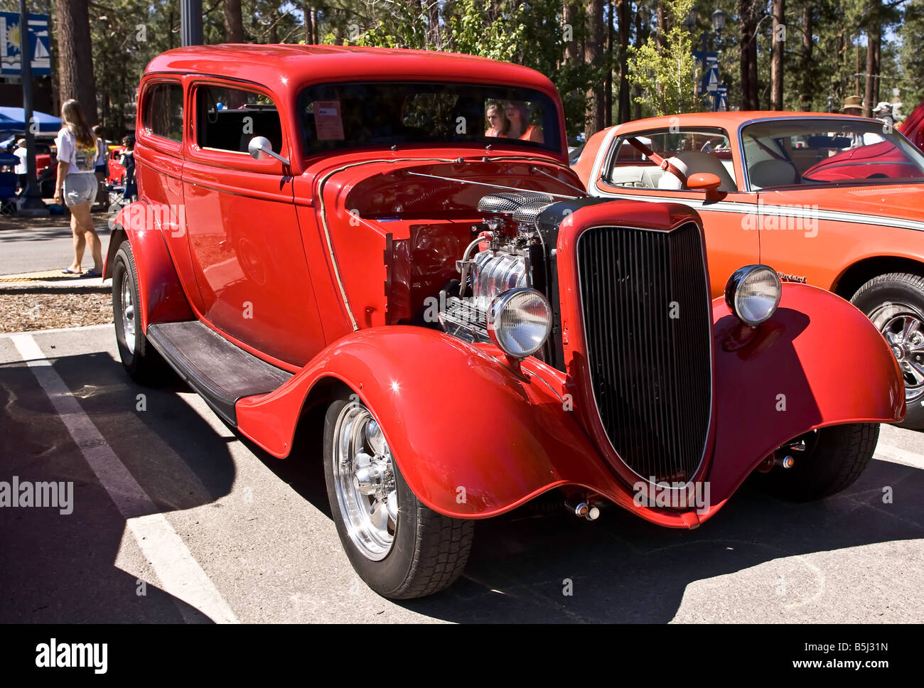 Red hot rod with a supercharged V8 engined coupe Stock Photo